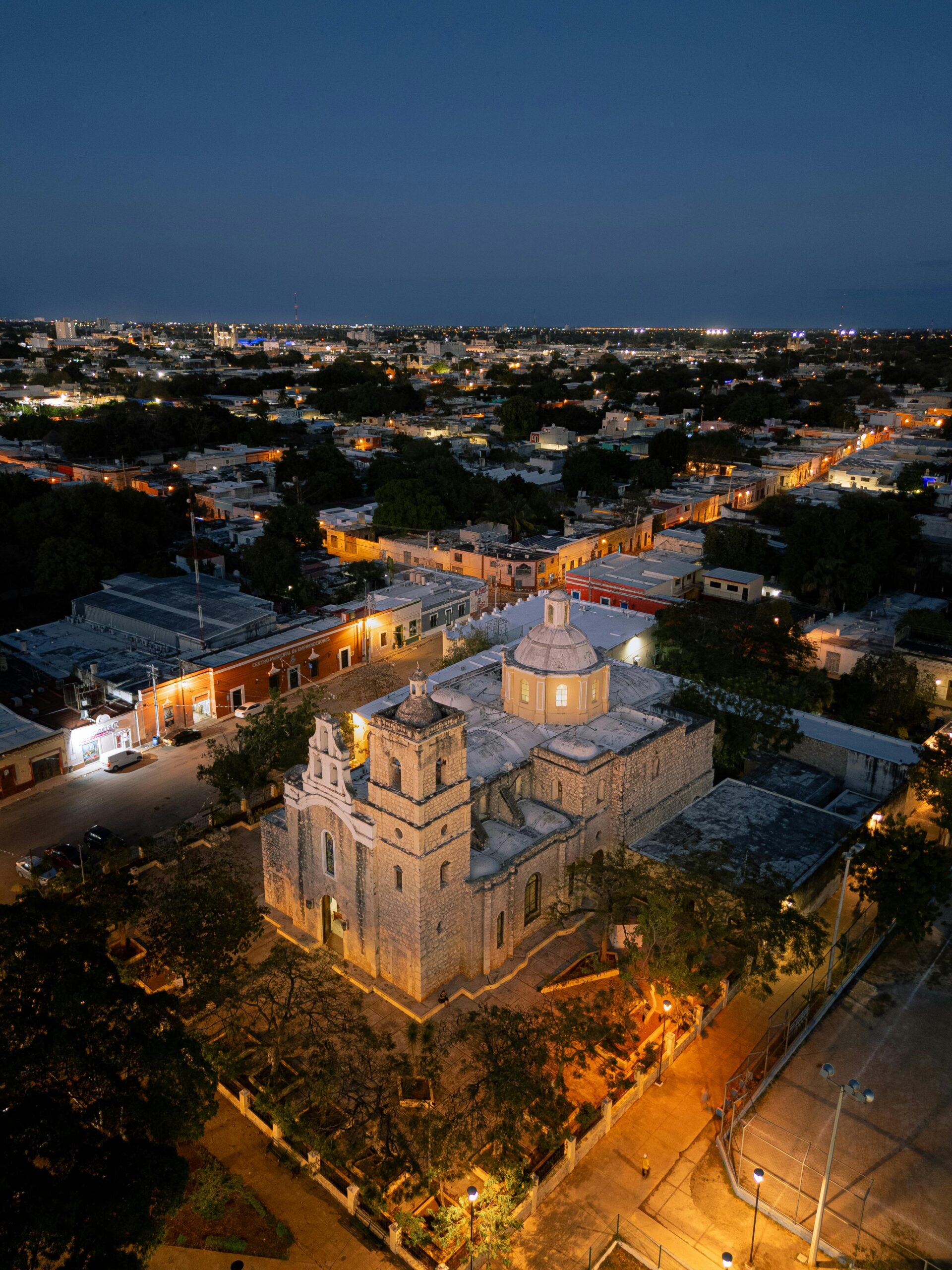 Drone shot showcasing Mérida Cathedral at night, highlighting the city's vibrant architecture.